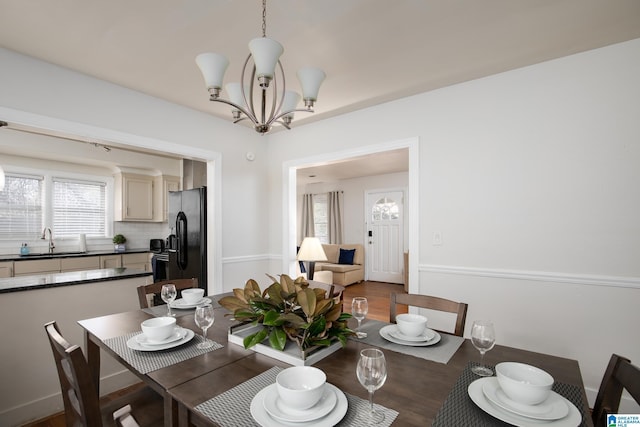 dining room with an inviting chandelier and sink