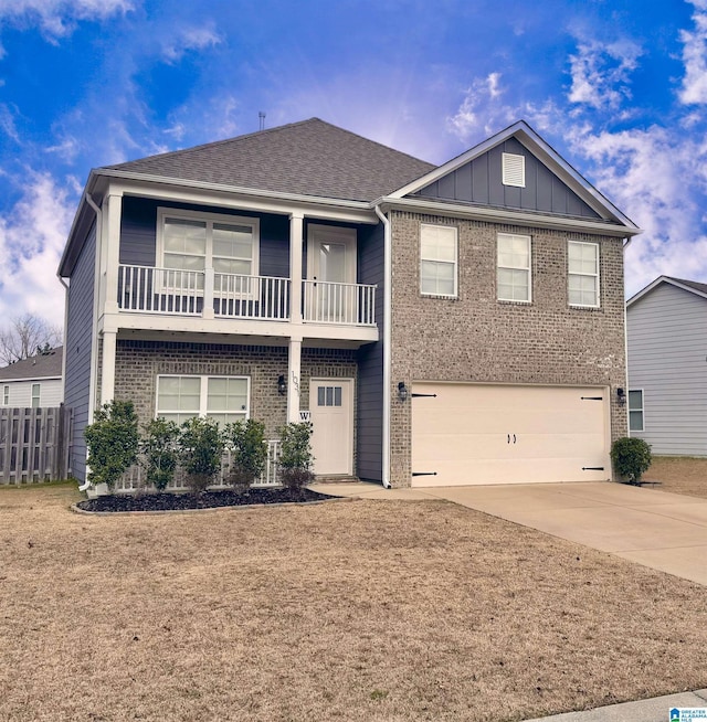 view of front of house with a garage, brick siding, driveway, board and batten siding, and a front yard