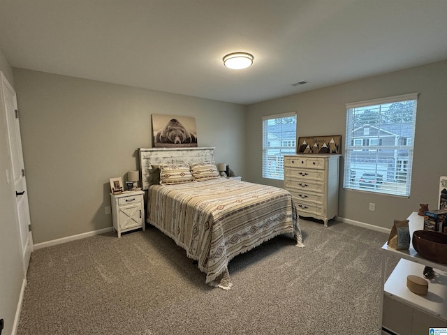 bedroom with dark colored carpet