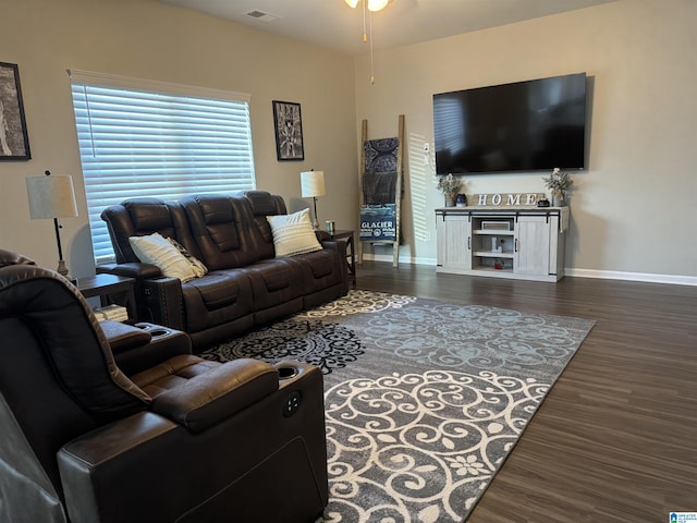 living room with ceiling fan and dark wood-type flooring