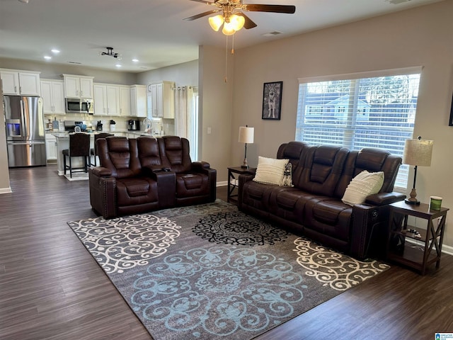 living room featuring dark hardwood / wood-style flooring, ceiling fan, and sink