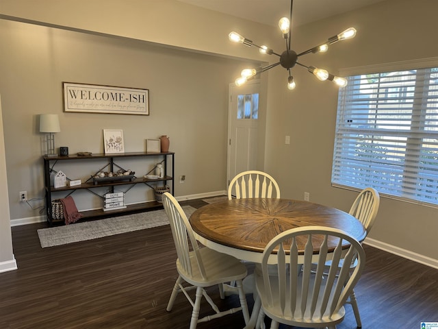 dining space with a chandelier and dark hardwood / wood-style flooring