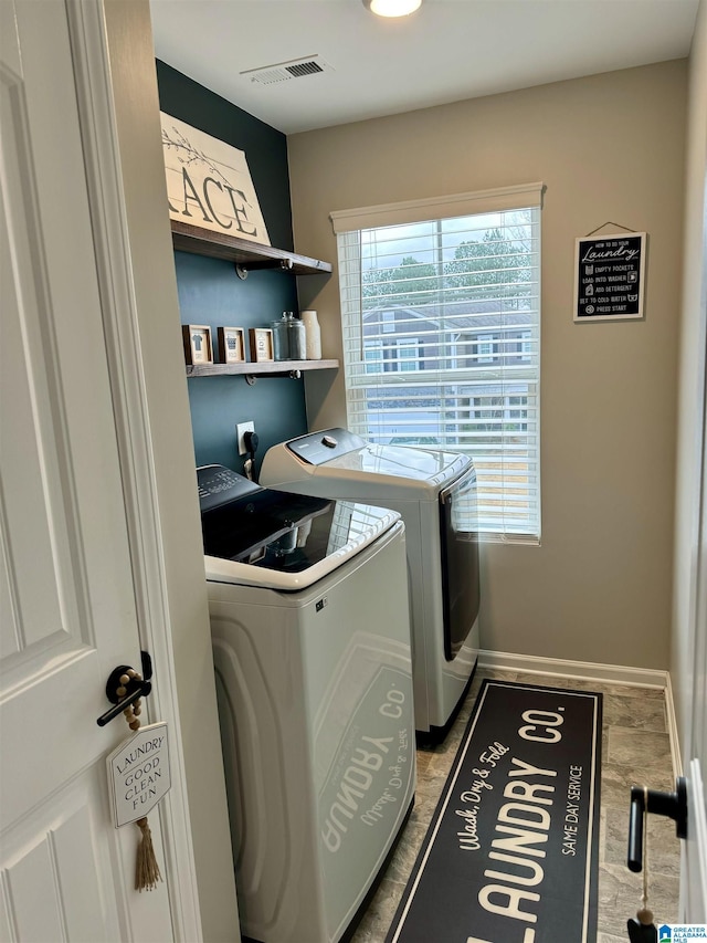 clothes washing area with washing machine and dryer