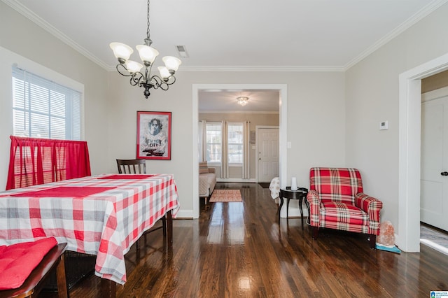 dining area with plenty of natural light, dark hardwood / wood-style flooring, crown molding, and an inviting chandelier