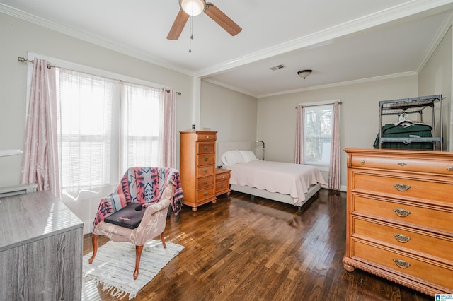 bedroom featuring dark hardwood / wood-style flooring, ceiling fan, and ornamental molding