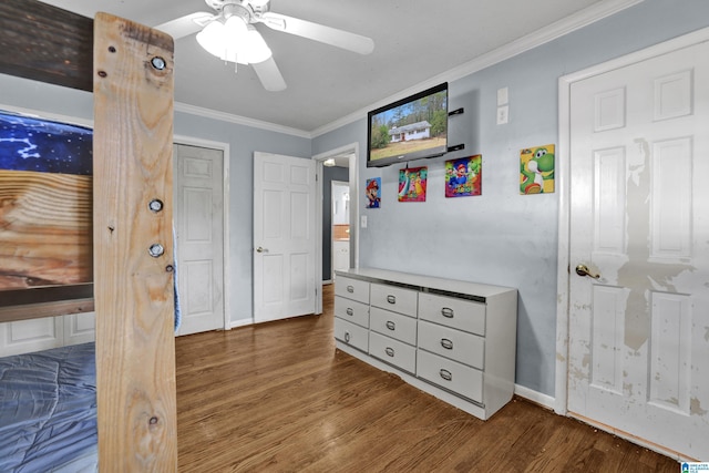 bedroom featuring hardwood / wood-style flooring, ceiling fan, and ornamental molding