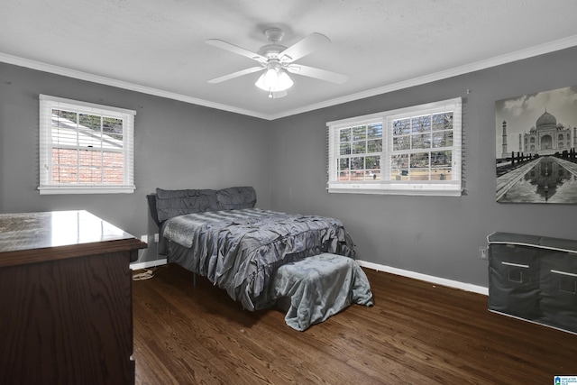 bedroom with dark hardwood / wood-style flooring, ceiling fan, and crown molding