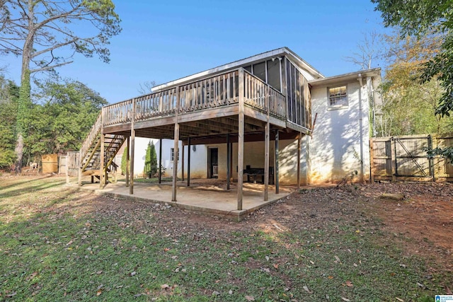 rear view of house featuring a patio and a deck