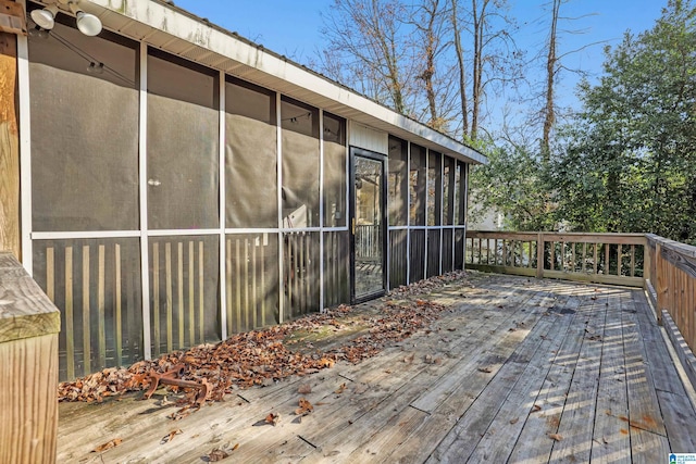 wooden deck with a sunroom