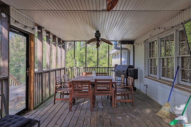 deck featuring ceiling fan and a grill