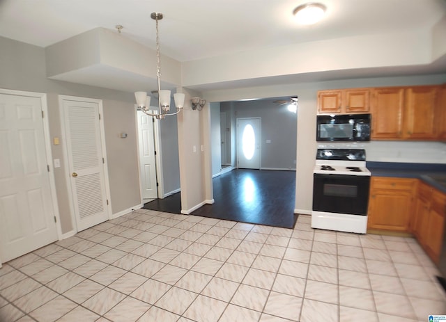 kitchen featuring white electric range, ceiling fan with notable chandelier, and pendant lighting