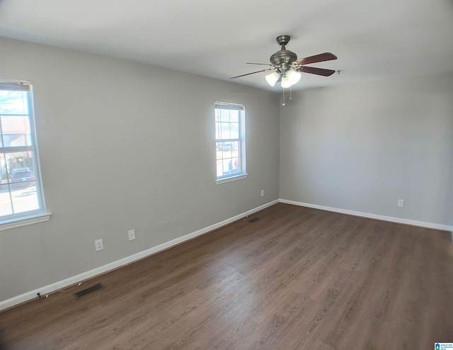 empty room featuring dark hardwood / wood-style floors and ceiling fan