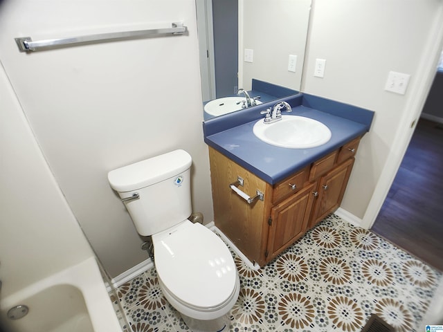 bathroom featuring tile patterned floors, vanity, and toilet