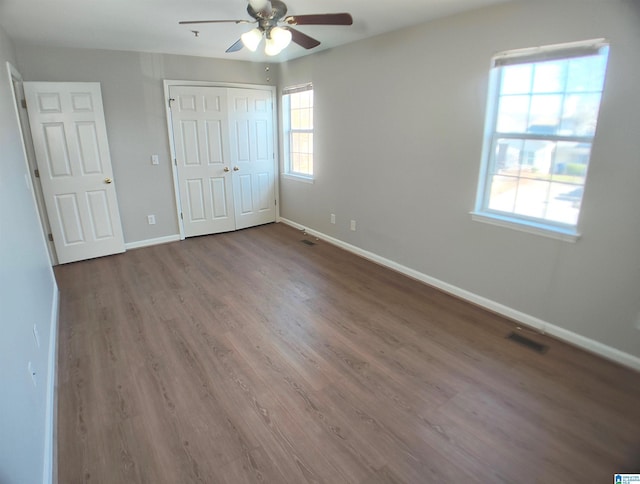 unfurnished bedroom featuring wood-type flooring and ceiling fan