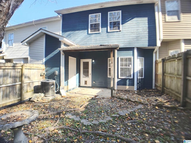 back of property featuring central AC unit and a patio