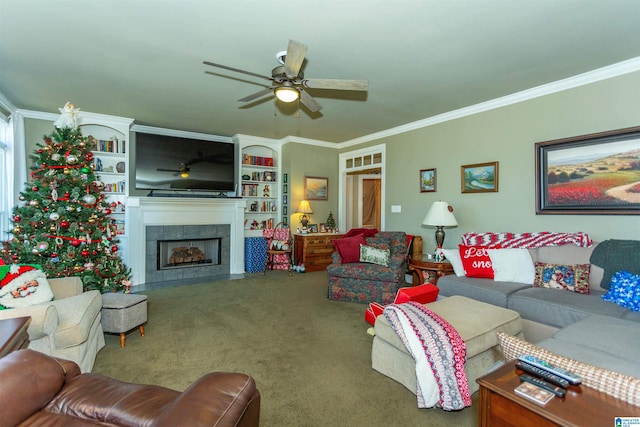 carpeted living room featuring ceiling fan, ornamental molding, and a tiled fireplace