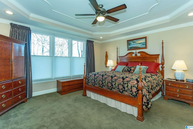 carpeted bedroom featuring a raised ceiling, ceiling fan, and ornamental molding