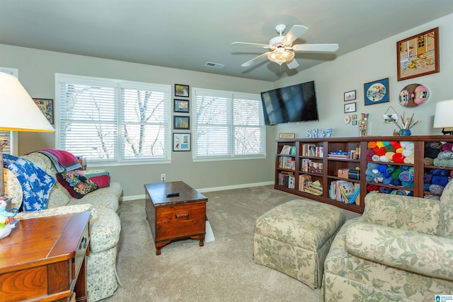 living room featuring carpet flooring and ceiling fan