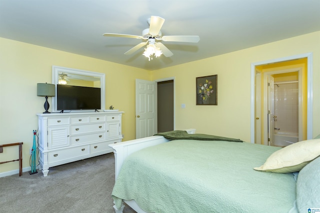 carpeted bedroom with connected bathroom and ceiling fan