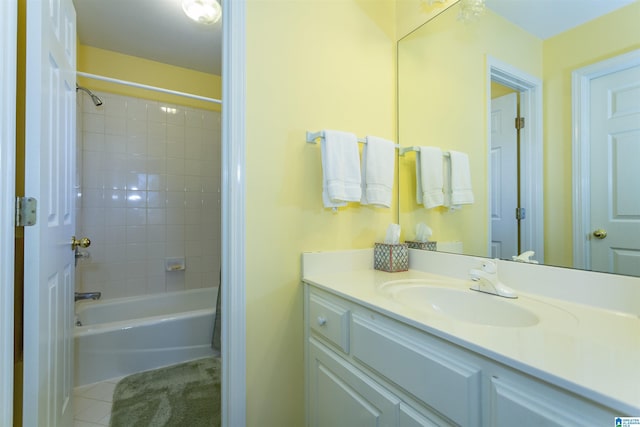 bathroom with tile patterned floors, vanity, and tiled shower / bath