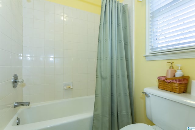 bathroom with toilet and shower / bathtub combination with curtain