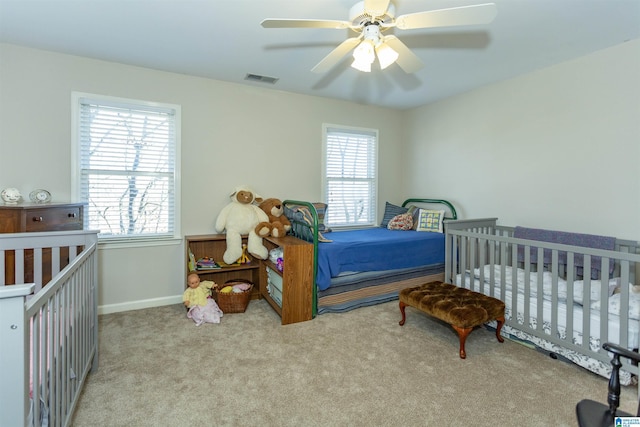 carpeted bedroom with ceiling fan