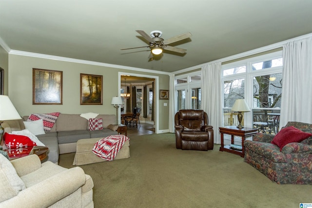 carpeted living room featuring crown molding and ceiling fan with notable chandelier