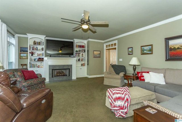 living room featuring dark colored carpet, ceiling fan, crown molding, and a tiled fireplace