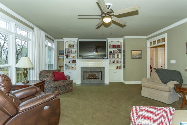 carpeted living room with crown molding, a fireplace, and ceiling fan