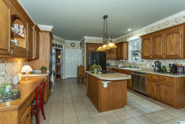 kitchen with a center island, stainless steel appliances, hanging light fixtures, and ornamental molding