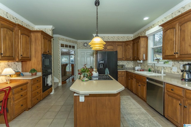 kitchen featuring crown molding, sink, black appliances, pendant lighting, and a kitchen island