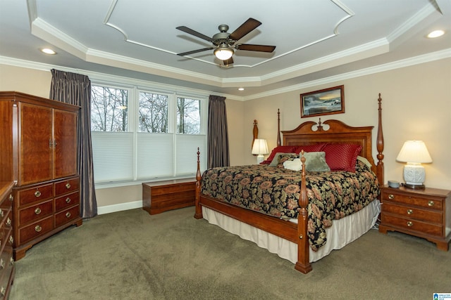 carpeted bedroom featuring a tray ceiling, ceiling fan, and crown molding