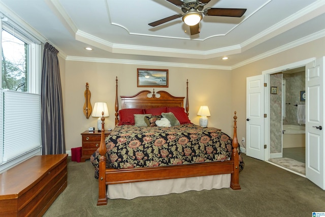 carpeted bedroom with ensuite bath, a raised ceiling, ceiling fan, and crown molding