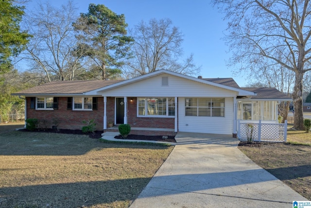 ranch-style house with a carport and a front lawn