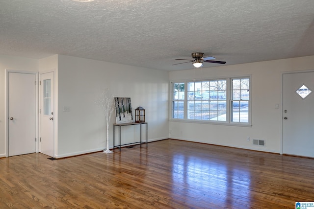 interior space featuring hardwood / wood-style floors, ceiling fan, and a textured ceiling