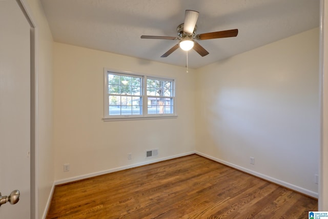 empty room featuring hardwood / wood-style floors and ceiling fan