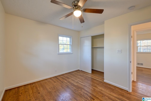 unfurnished bedroom featuring hardwood / wood-style flooring and ceiling fan