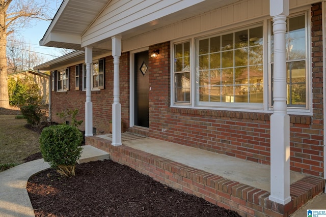 view of exterior entry featuring a porch