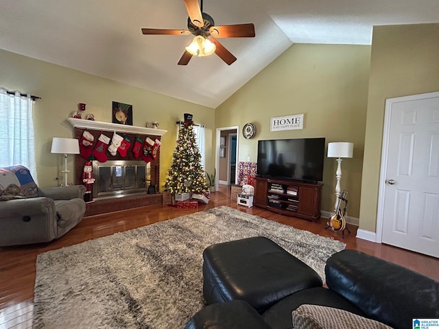 living room featuring ceiling fan, dark wood-type flooring, and lofted ceiling