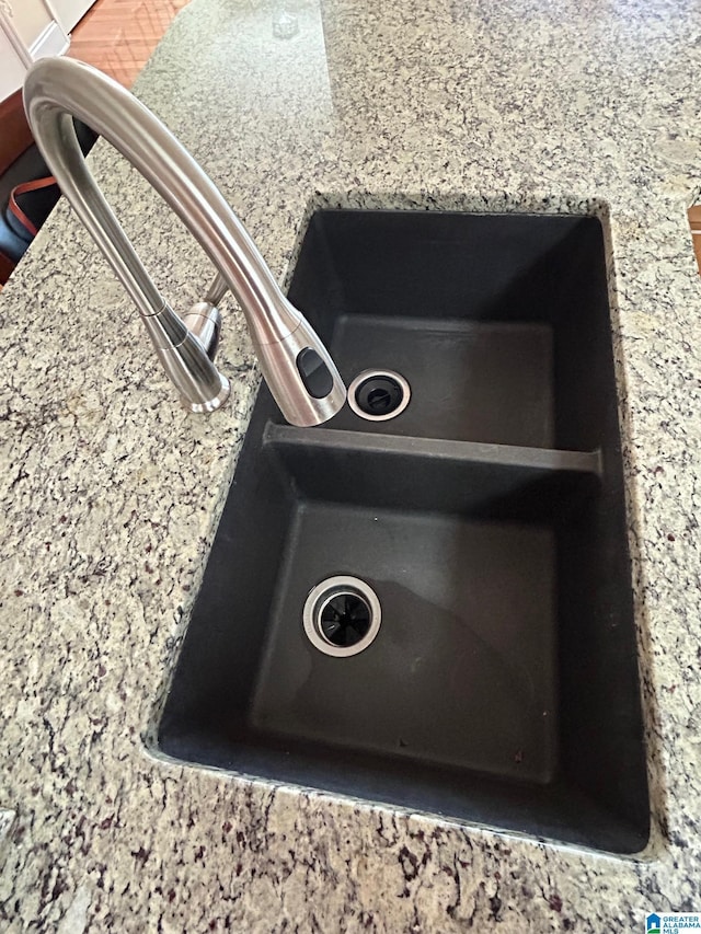 interior details with light stone countertops and sink