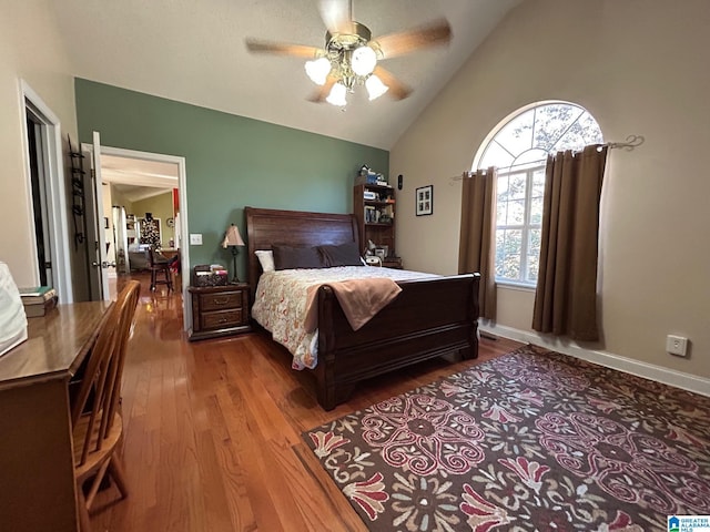 bedroom with ceiling fan, wood-type flooring, and lofted ceiling