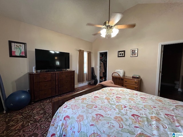 bedroom featuring ceiling fan, a walk in closet, vaulted ceiling, and a closet