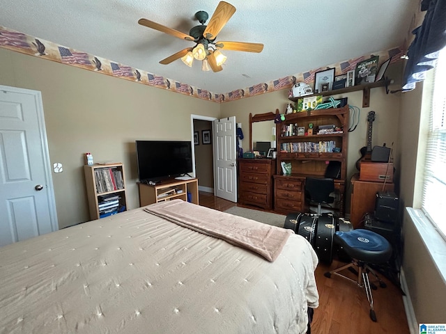 bedroom featuring a textured ceiling, ceiling fan, and hardwood / wood-style floors