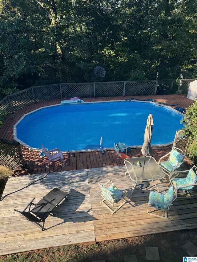 view of swimming pool featuring a deck