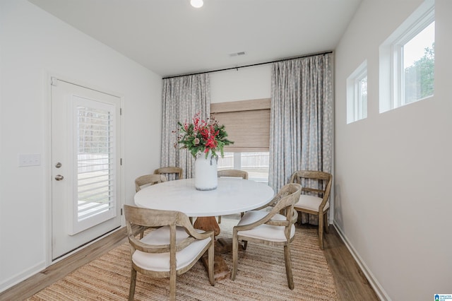 dining area featuring plenty of natural light and wood-type flooring