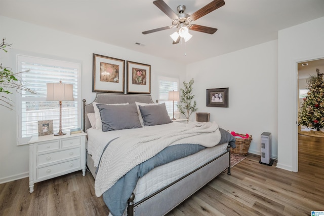 bedroom with hardwood / wood-style flooring and ceiling fan