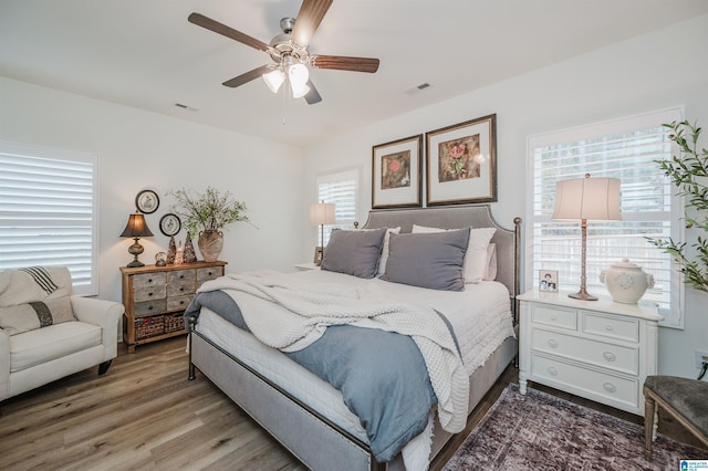 bedroom with ceiling fan and wood-type flooring