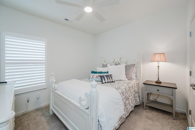 carpeted bedroom featuring multiple windows and ceiling fan