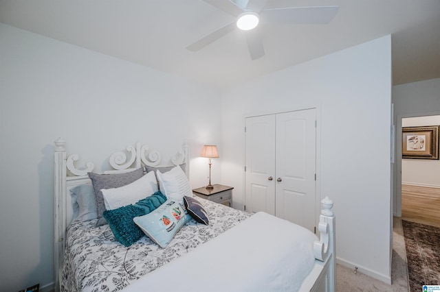 bedroom featuring a closet, ceiling fan, and light colored carpet