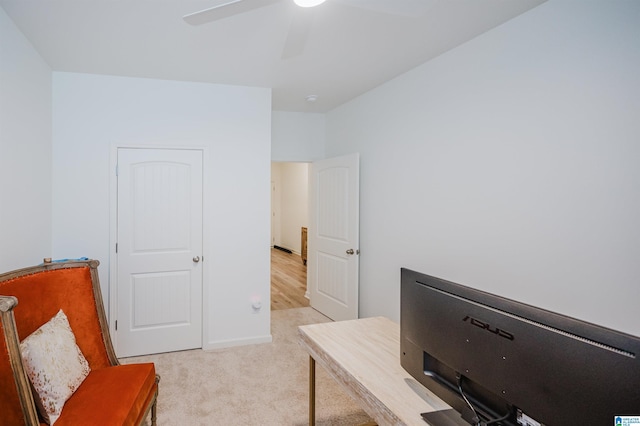 carpeted office space featuring ceiling fan